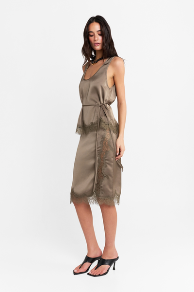 Full-length studio side profile view of a model wearing the two-piece satin set cinched at the waist with a thin tie belt, showcasing the lace trim details.