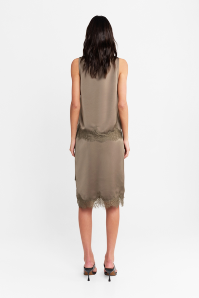 Studio rear view of a model wearing the matching satin tank top and skirt set in thyme, highlighting the clean back silhouette and lace-trimmed hems.