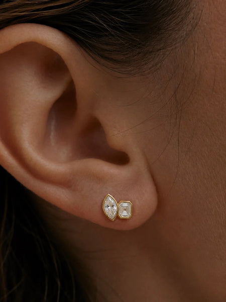Close-up of another earlobe wearing the gold stud, showing the clean fit and modern design.
