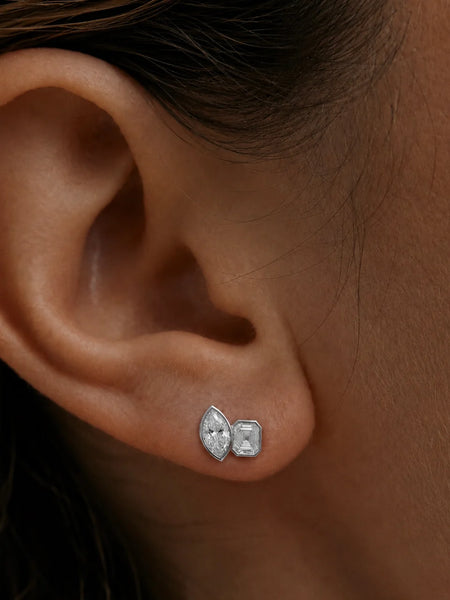 Close-up profile of a model's earlobe wearing the silver Marguerite stud, highlighting its clean 925 sterling silver setting and multi-cut silhouette.
