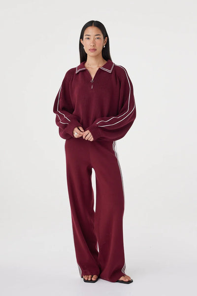 A full-length front studio shot with the model standing in a relaxed pose, illustrating the organic cotton blend fabric drape and ease of movement.