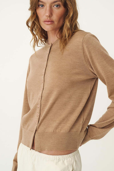 Close-up detail shot of the ROWIE Maeve Merino Spring Cardigan in Fawn Marle, highlighting the rolled hem around the round neckline, matching front buttons, and ribbed cuff finish.