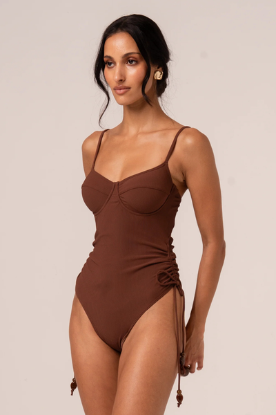 A three-quarter side angle profile view displaying the flexible fit around the waist and the clean profile achieved with internal removable padding.