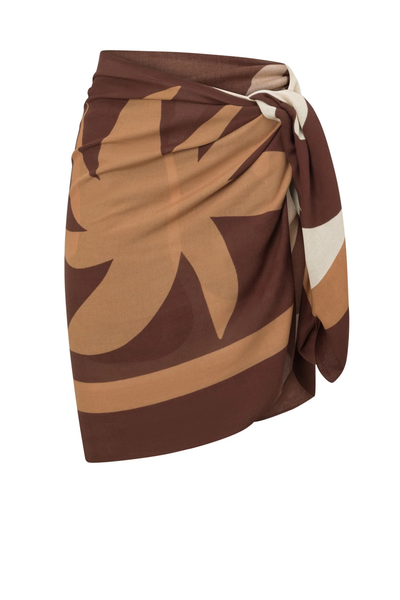 A front view of the bestselling Ochre Lane Sombra Sarong in classic black, showcasing the fluid, semi-sheer fabric knotted gracefully at the hip over tonal swimwear.