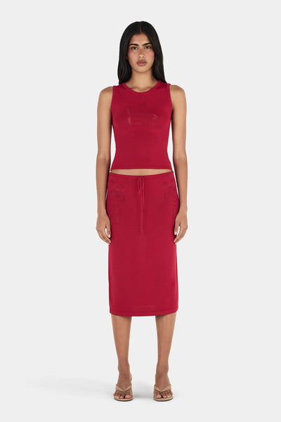 Full-length front view of model wearing the Ownley Inka Top in Lipstick, a red sleeveless knit top styled with a matching red knit midi skirt.