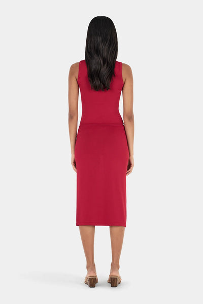 Full rear view of model wearing the red sleeveless Ownley Inka knit tank top and high-waisted midi skirt set.