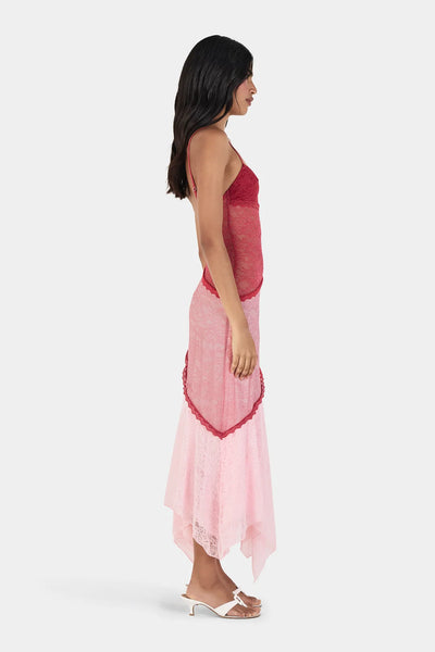 Side profile view of model wearing the Ownley Alida Midi Dress in Ballet Splice, demonstrating the sheer lace waist detailing and layered asymmetrical lace skirt panels.
