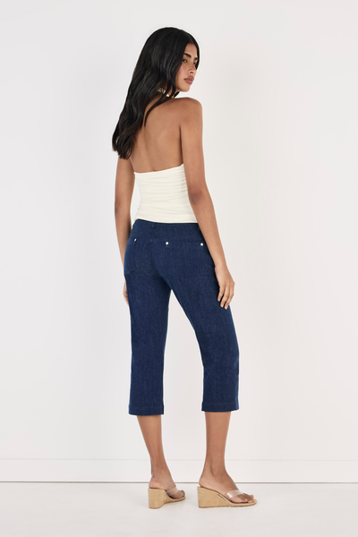 Shop the OWNLEY Yoita Top in Ivory online. Features a crossover halter neckline, center front keyhole cut-out, and ruched side detailing. Free shipping options available.