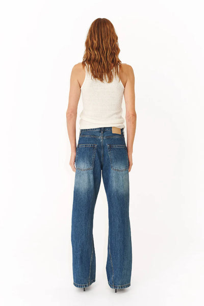 Back view of the Percy Curve Seam Jeans, illustrating the clean pocket placement and the flattering, structured drape of the heavy-weight denim.