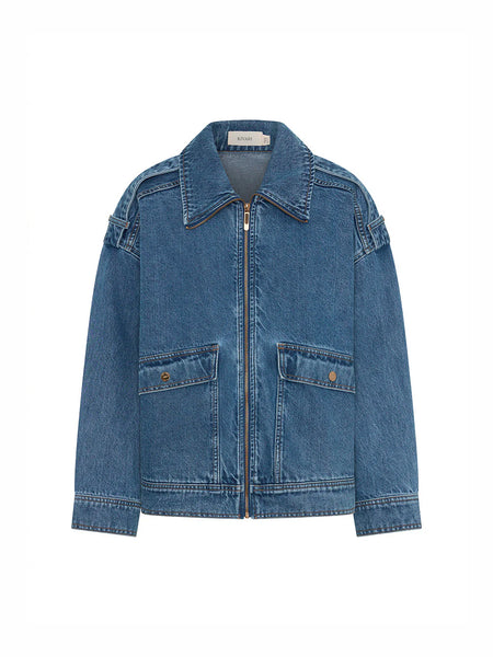 A clean, standalone e-commerce ghost mannequin shot of the Kivari Rita Denim Jacket in Drift Blue against a solid white background, displaying its symmetrical construction, exposed center zip closure, and wide collar.