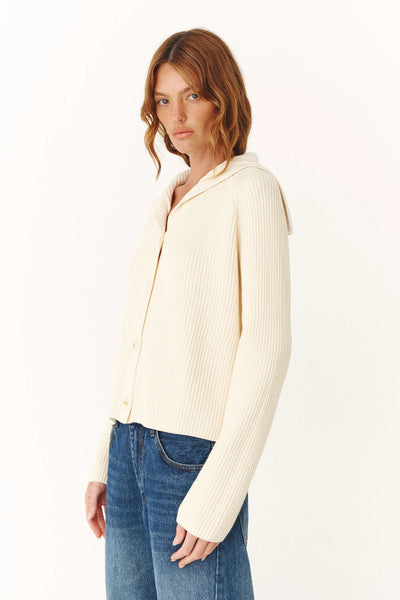 Model wearing the Snow Saylor cardigan, illustrating the relaxed fit and lightweight drape of the zero-waste knit construction.