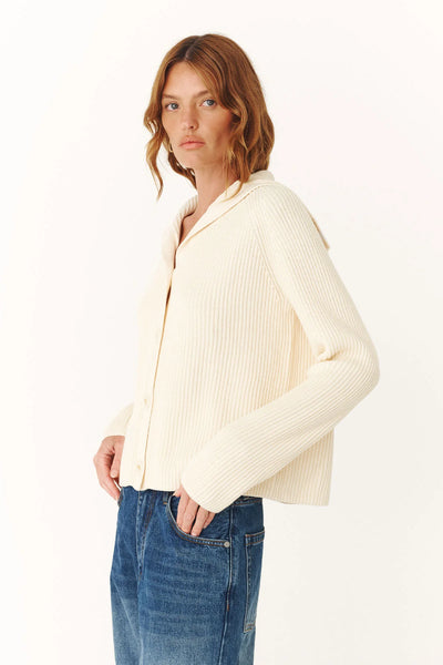 Rear view of the Saylor Knit Cardigan in Snow, showcasing the flat-lying wide sailor collar and the consistent ribbed texture across the back.