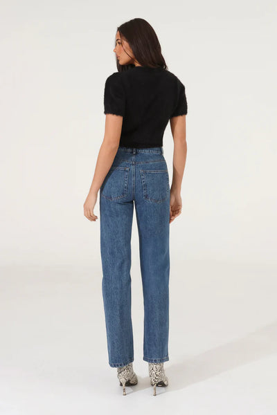 A full-length e-commerce studio shot from behind, highlighting the premium texture and clean back silhouette of the black Ruby fluffy knit tee paired with straight-leg denim.