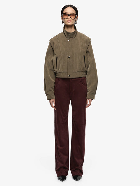 A front shot focusing on the closed jacket bodice, highlighting the clean alignment of the metal press-stud button closures and the relaxed, insulated drape.