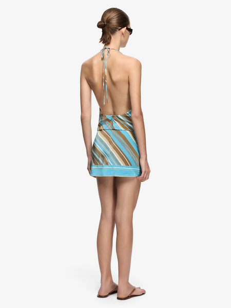 Full-body back view highlighting the low-back design, self-tie halter neck, and fitted mini skirt.