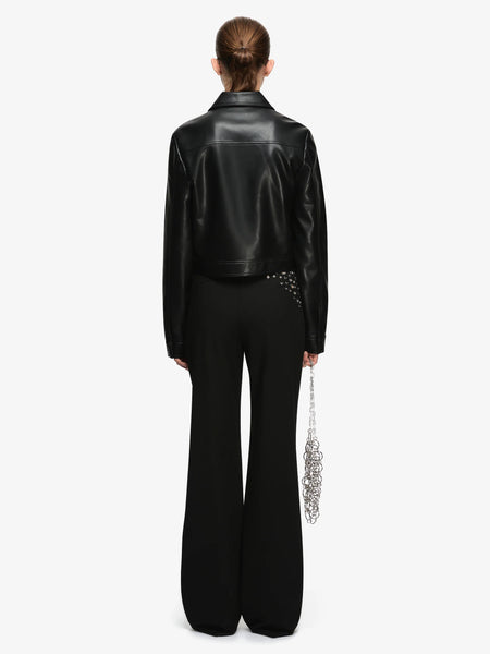 Full back view studio shot showing the back yoke stitching and cropped waistline of the Bec + Bridge Saphira Cropped Jacket in Black faux leather.
