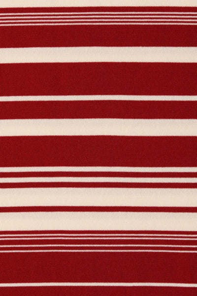 Close-up fabric texture shot displaying the horizontal red ochre and cream striped pattern of the fine-knit material.