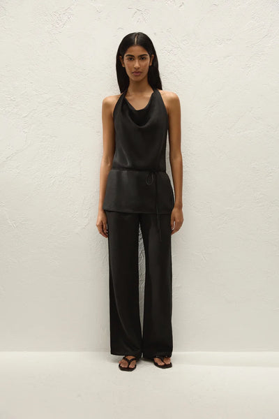 Full-length studio front view of a model standing straight in the matching black halter top and tailored straight-leg trousers.
