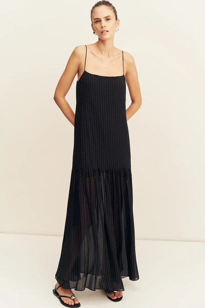 Front view of a model posing with hands behind her back in the relaxed-fit Shona Joy Irving Polka Dot Maxi Dress in Black Polka Stripe.