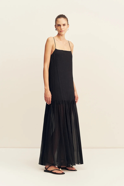 Three-quarter front view of a model wearing the straight-cut Shona Joy Irving Polka Dot Maxi Dress in Black Polka Stripe.