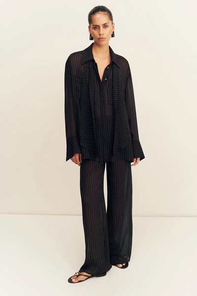 Full-length front studio view of a model in the semi-sheer Shona Joy Irving Polka Dot Sheer Pant in Black Polka Stripe styled as a matching set.