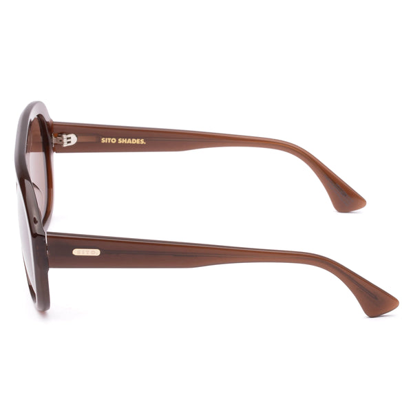 Side profile view of translucent milky coco aviator sunglasses showcasing the thick acetate temple arm and gold-toned "SITO" logo hardware insert.