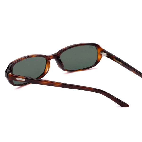 Back perspective studio view of the Sito Shades Roux sunglasses in Classic Tort acetate showing inner gold temple branding, silver hinges, and grey lenses on a white background.
