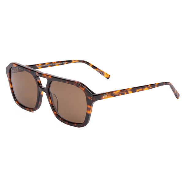 A front-facing e-commerce product studio shot of "The Void" sunglasses isolated against a pure white background. The image clearly showcases the 70s-inspired aviator silhouette with a distinct tortoise shell pattern frame, a geometric open double nose bridge, and brown lenses. The subtle "SITO" branding is lightly etched in the upper corner of the left lens.