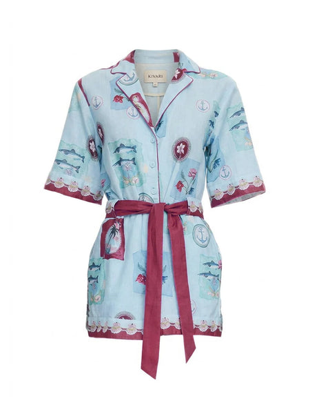 Front  view of the Sintra Playsuit in Blue, showcasing the button-down bodice, collared neckline, and intricate broderie anglaise detailing on the sleeves and hem.