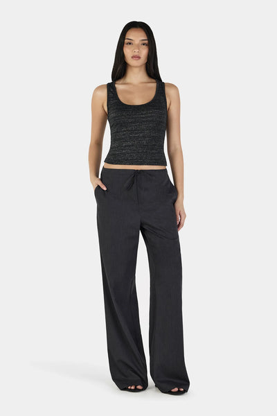 A clear front-profile image focusing from the waist down, illustrating the relaxed hang of the poly-wool fabric and how the straight-leg line cleanly frames footwear.