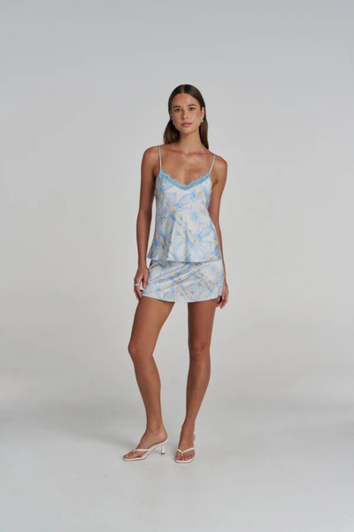 Studio rear view of a model wearing the blue and white printed camisole, showcasing the thin adjustable straps and straight hemline.