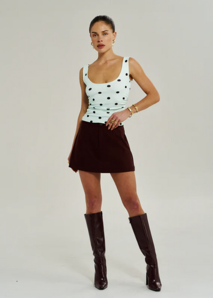 Model wearing the Summi Summi A-line skirt in Syrah, showcasing the clean waistline and the way the fabric flares slightly for ease of movement.