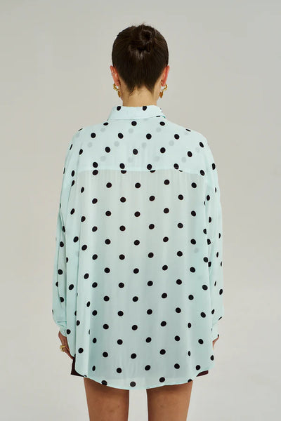 A back view of the Pinot Drops motif on the Dotty shirt, showing the intricate deep red abstract print and the lightweight 90g fabric texture.
