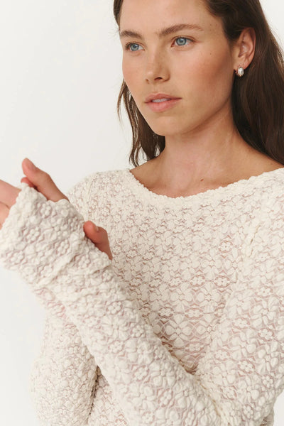 A refined and feminine layering piece in a floral Creme lace, perfect for wearing under blazers or as a stand-alone sheer statement top.