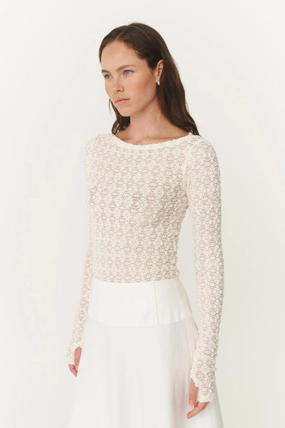 Side profile of the Samantha top on a 180cm model, highlighting the seamless fit and the elegant drape of the long sleeves.