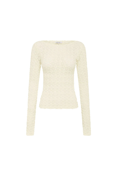 A fitted long-sleeve lace top in Creme, featuring a delicate clover-inspired floral motif and a sophisticated boat neckline.