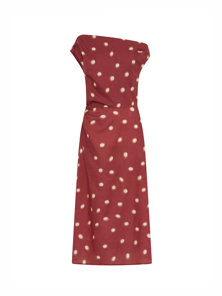 A clean e-commerce ghost mannequin shot of the Kivari Saro Midi Dress in Brick against a solid white backdrop, clearly displaying its one-shoulder construction, subtle waist gathers, and ivory polka-dot pattern.