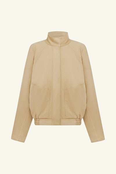 Front flat lay view of the Shona Joy Ernest Faux Suede Bomber Jacket in sand showing stand collar, concealed press stud placket, raglan sleeves, and elasticated hem.
