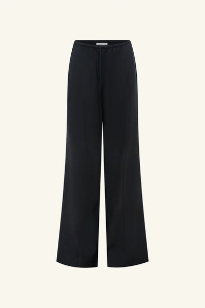 Front studio view of the Shona Joy Castro Suiting Drawstring Pant in black featuring pintuck front details, wide legs, and an adjustable tied waistband.