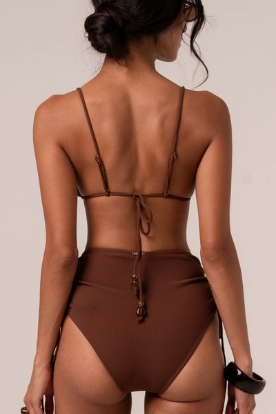 A three-quarter side angle studio view displaying the high-stretch flexibility and textured handfeel of the premium ribbed Nylon-Spandex fabrication.