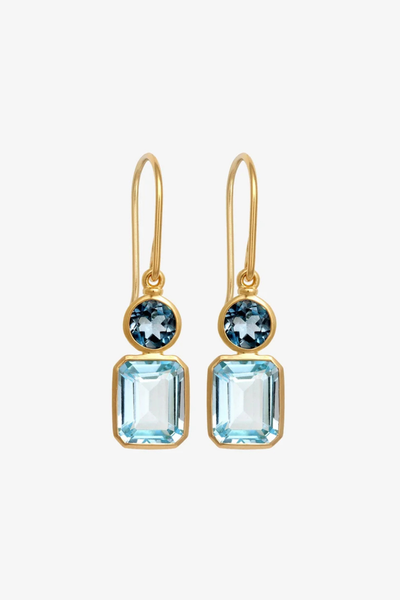 Front product shot of a pair of Temple of the Sun Aqua Earrings in 18k Gold Vermeil showcasing round London Blue Topaz and emerald-cut Sky Blue Topaz gemstones on gold drop hooks against a white background.