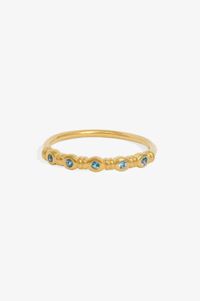 Studio product shot of the Temple of the Sun Aqua Ring in 18k Gold Vermeil set with five round teal topaz stones on a white background.