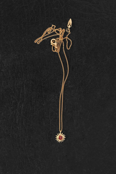 Flat-lay view of the Temple of the Sun Aten Necklace in 18k Gold Vermeil laid out on a dark textured surface, showing the clasp, chain, and pendant.