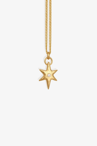 Studio product shot of the Temple of the Sun Electra Necklace in 18k Gold Vermeil featuring a star pendant set with a central white zircon on a gold chain against a plain background.