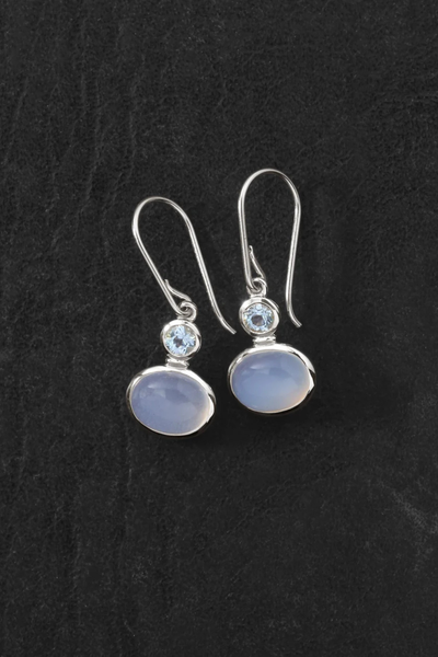 Side-angle portrait of a model showcasing the length and gemstone detail of the Temple of the Sun Ether Earring in Sterling Silver.