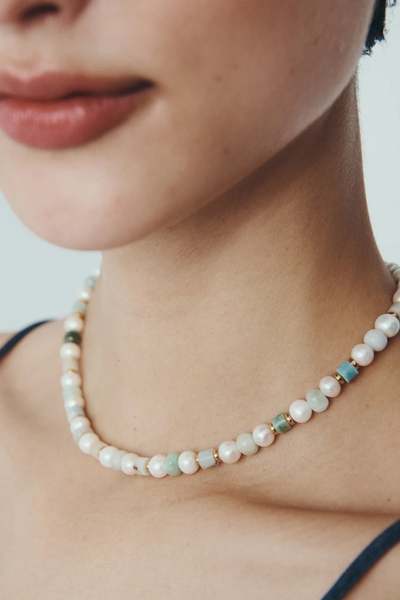 Close-up crop of a model wearing the Hydra Necklace, highlighting the alternating jade and pearl textures.