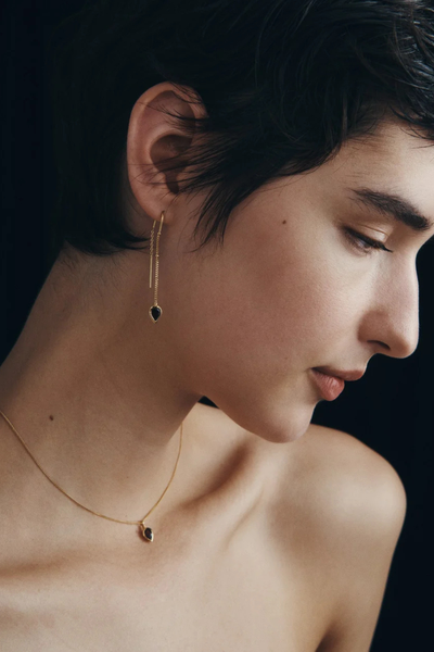 Side-angle profile photo of a model wearing the Temple of the Sun Ignis Necklace in 18k Gold Vermeil paired with the matching Ignis threader earrings.