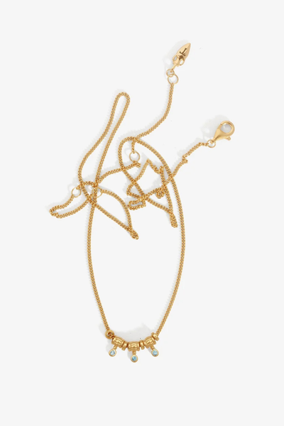 Studio product shot of the Temple of the Sun Isla Necklace in 18k Gold Vermeil displaying its fine chain and three dangling London Blue Topaz station charms on a white background.