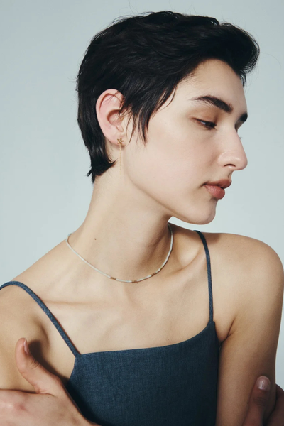 Side-profile photo of a model wearing the Temple of the Sun Seba Stud Earring in 18k Gold Vermeil.
