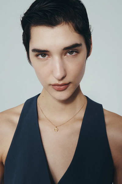 Direct studio portrait of a model wearing the Temple of the Sun Soma Coin Necklace in 18k Gold Vermeil.
